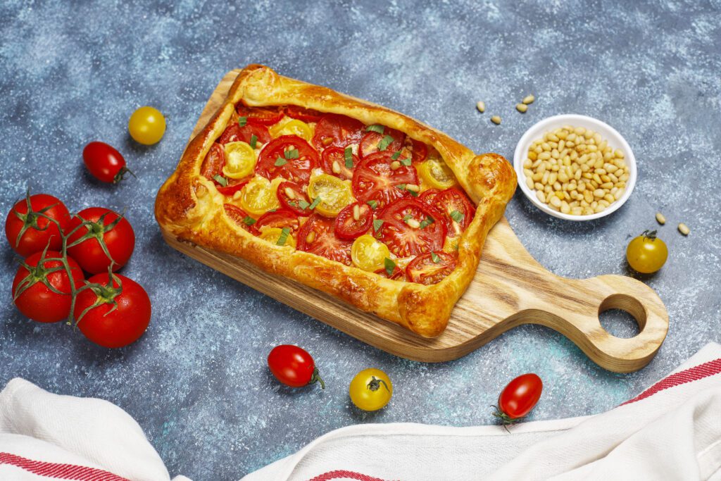 delicious homemade rustic open pie galette with various tomatoes pine nuts